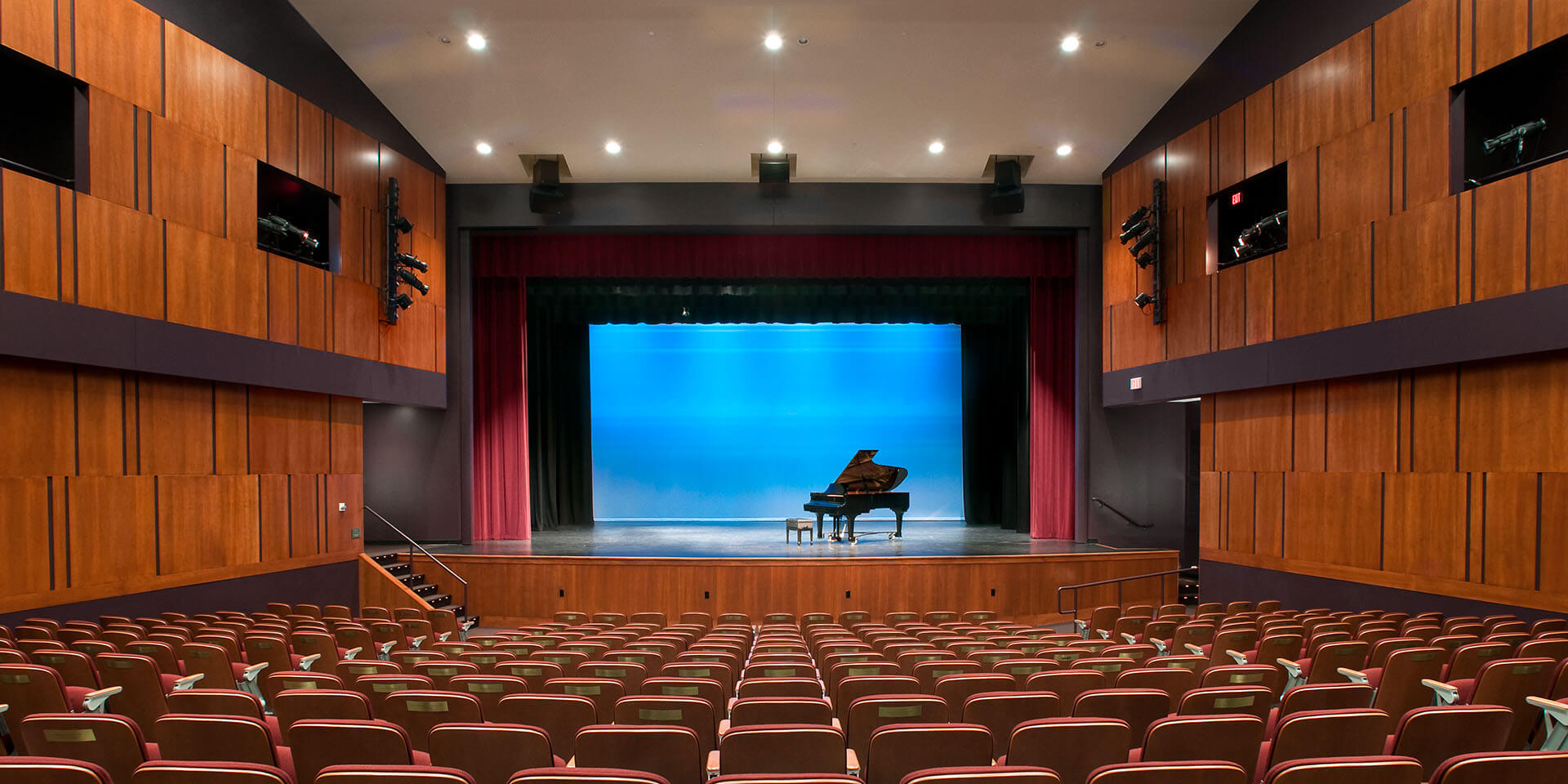 Fryeburg Academy performing hall with a piano on the stage