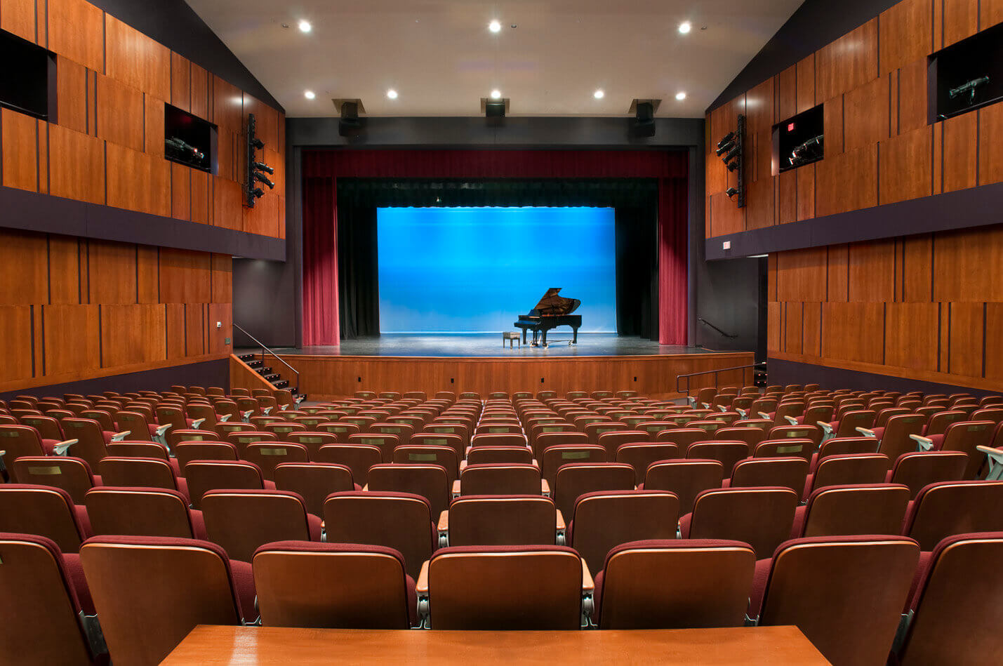 Fryeburg Academy performing hall with a piano on the stage