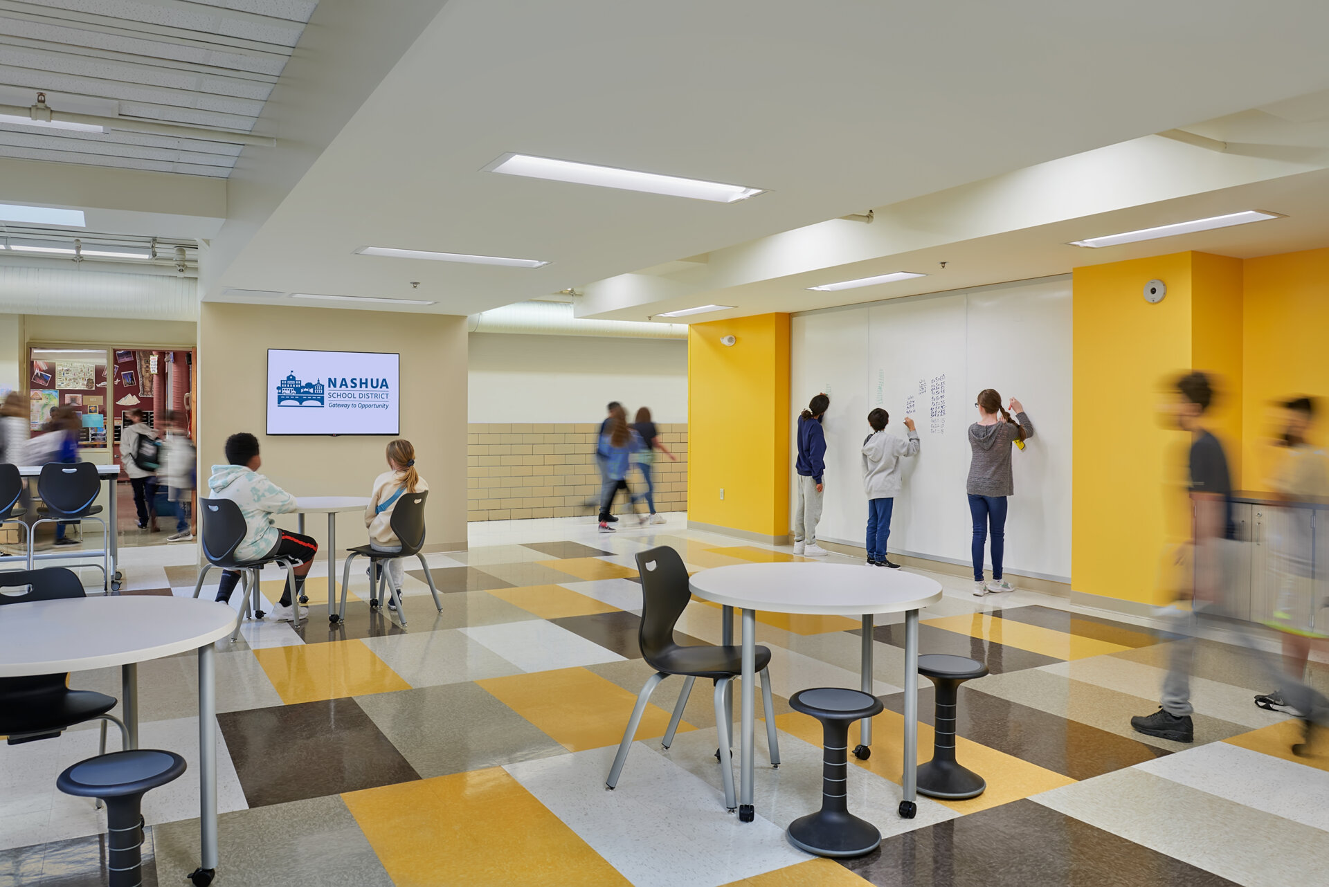 Digital rendering of students working in a Nashua Middle school common room