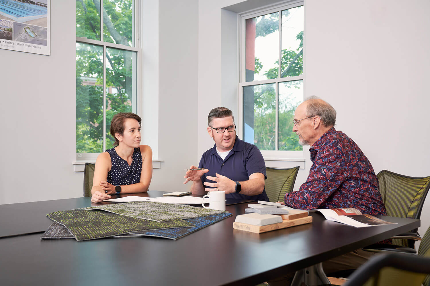 Architects looking over several different blueprints