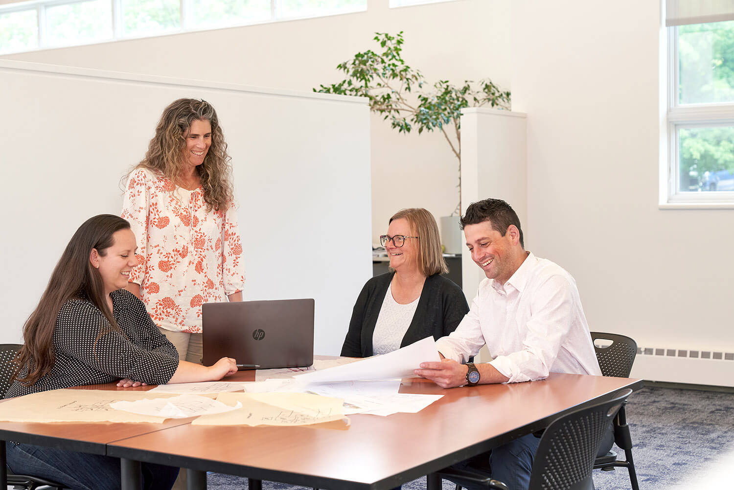 Architects looking over several different blueprints